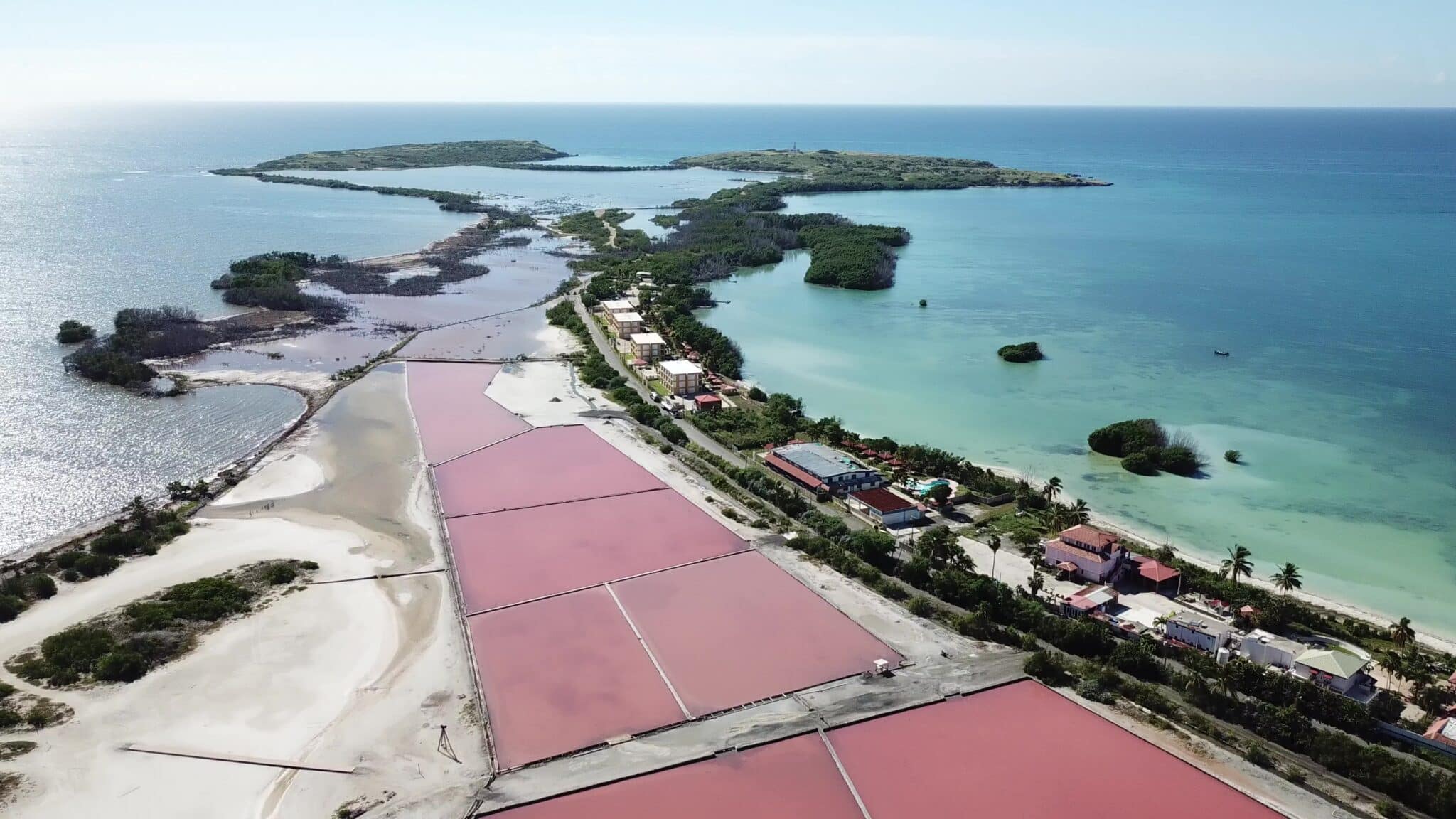 Pink ponds surrounded by sea on boths sides